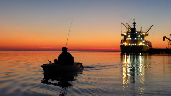 photo of fisherman at sunset