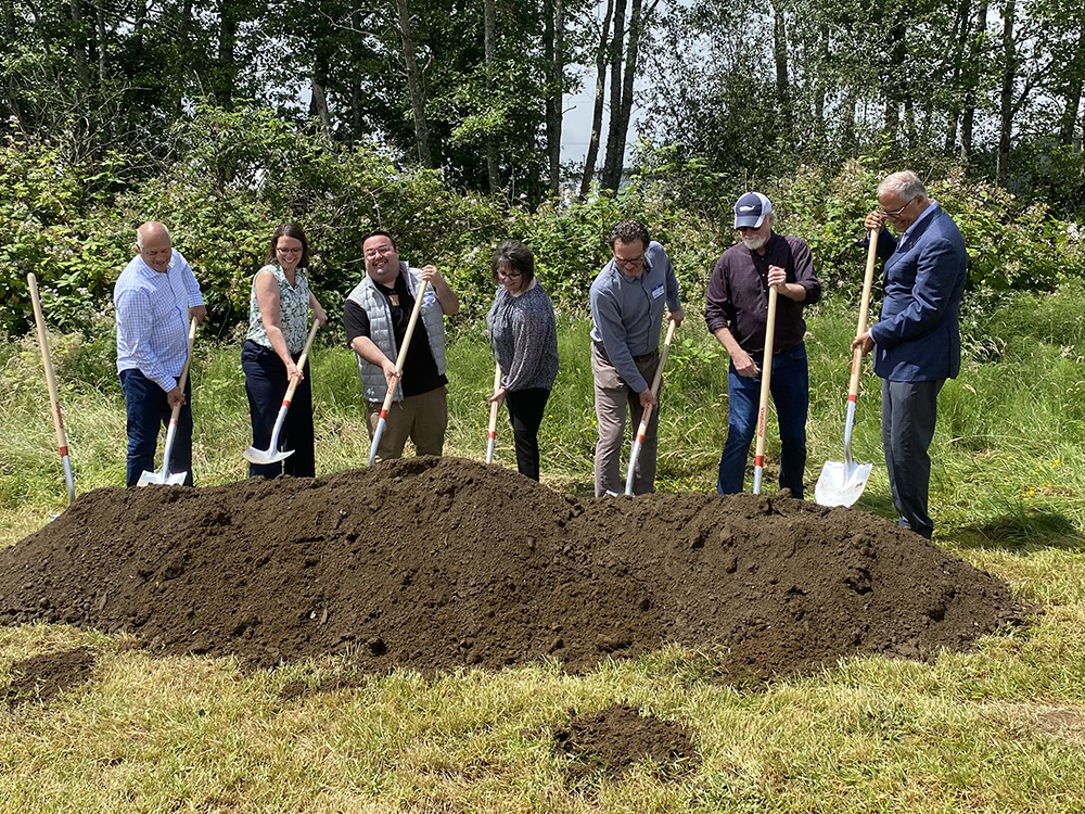People with shovels breaking ground at the future Fry Creek pump station in 2022