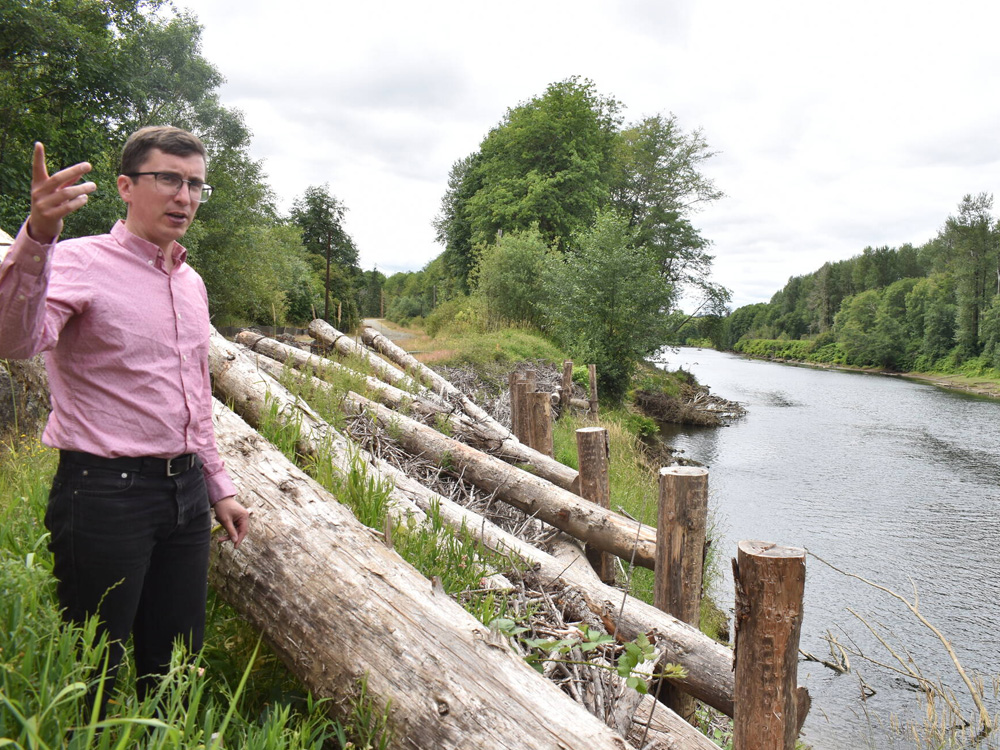 Kris Koski, engineer for the Port of Grays Harbor, stands next to an erosion-reduction project